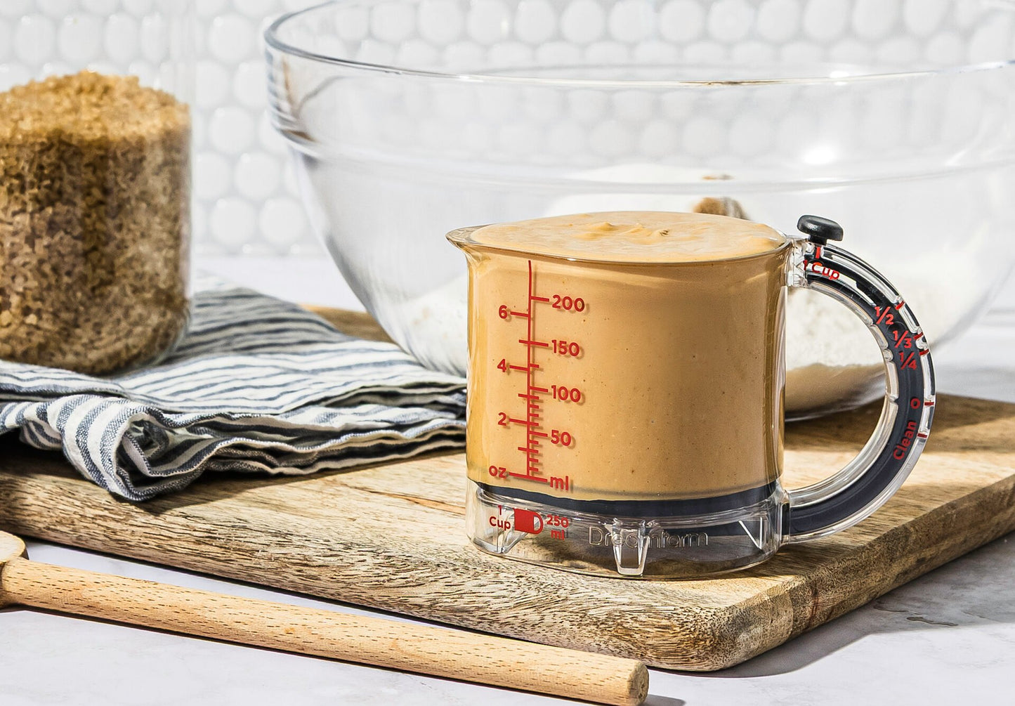 Upcup is a 4-in-1 adjustable measuring cup that scrapes itself clean for wet, dry, and sticky ingredients.