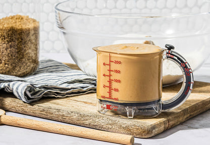 Upcup is a 4-in-1 adjustable measuring cup that scrapes itself clean for wet, dry, and sticky ingredients.